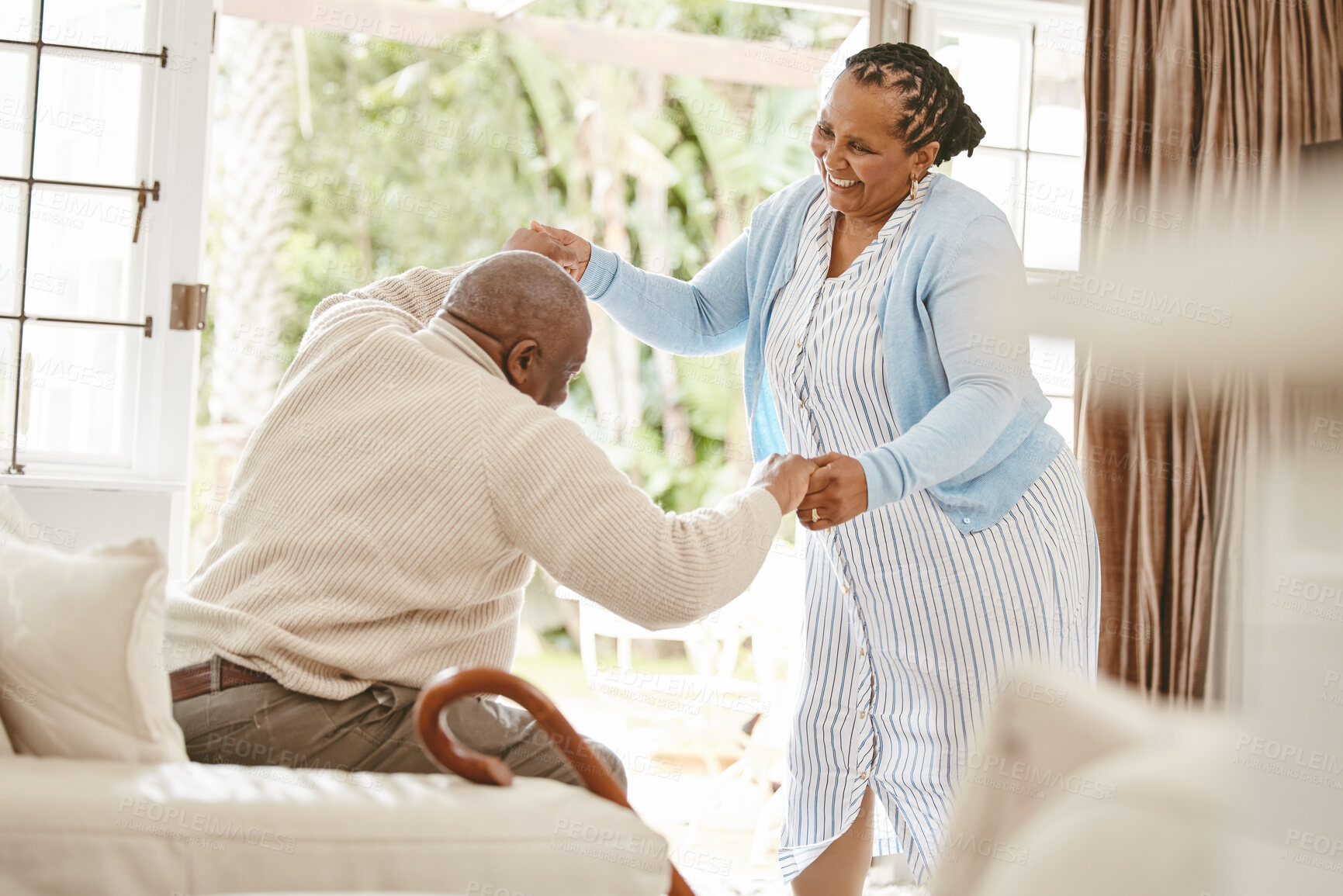 Buy stock photo Senior, couple and happy with dancing in home for favorite song, radio playlist or commitment in marriage. African people, person with disability and dancer wife for retirement fun or romance on sofa