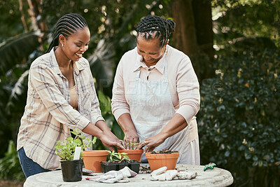Buy stock photo Shot of a mother and daughter gardening together in their backyard