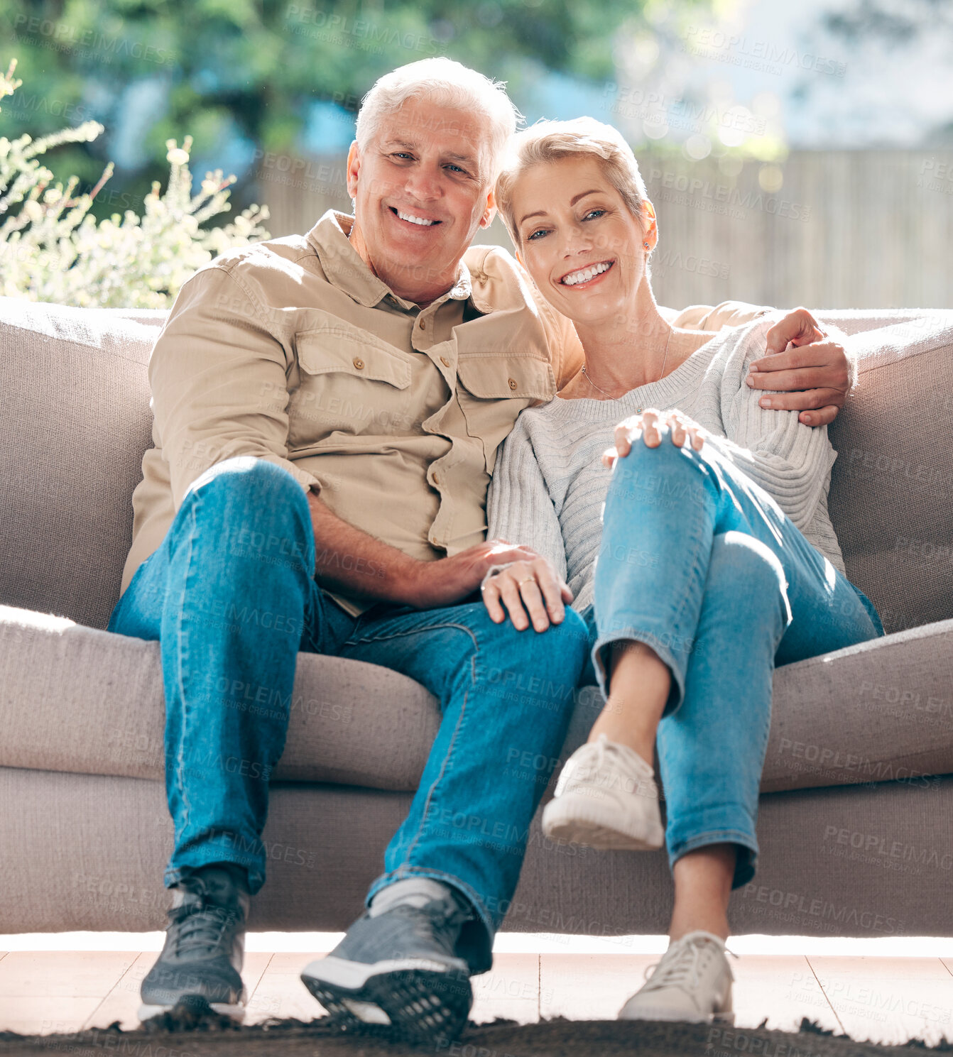 Buy stock photo Portrait of a happy senior couple relaxing on the sofa at home