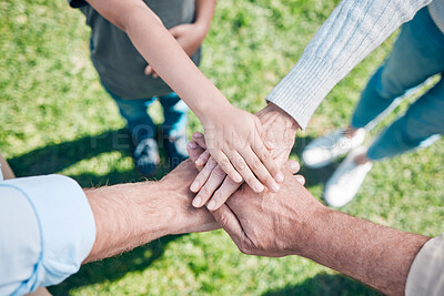 Buy stock photo Shot of a group of unrecognizable family members stacking their hands outside