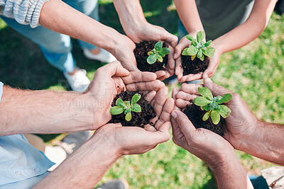 Buy stock photo Shot of a group of unrecognizable people holding plants growing out of soil
