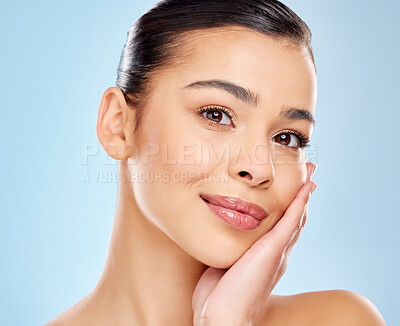 Buy stock photo Happy, girl and portrait in studio for skincare or health, dermatology and skin treatment for self care. Woman, calm and isolated on blue background with natural cosmetics, glow and beauty shine.