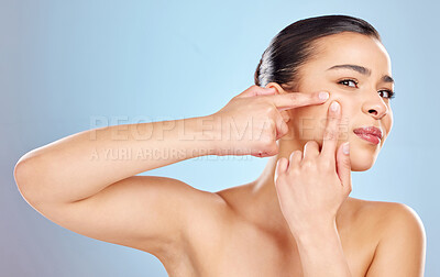 Buy stock photo Woman, pimple and squeeze in studio for skin care and remove blackhead on blue background. Female person, hands and cleaning pores or acne, facial treatment and pop zit or spot for wellness health