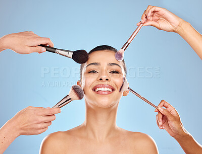 Buy stock photo Studio portrait of an attractive young woman having makeup applied to her face against a blue background