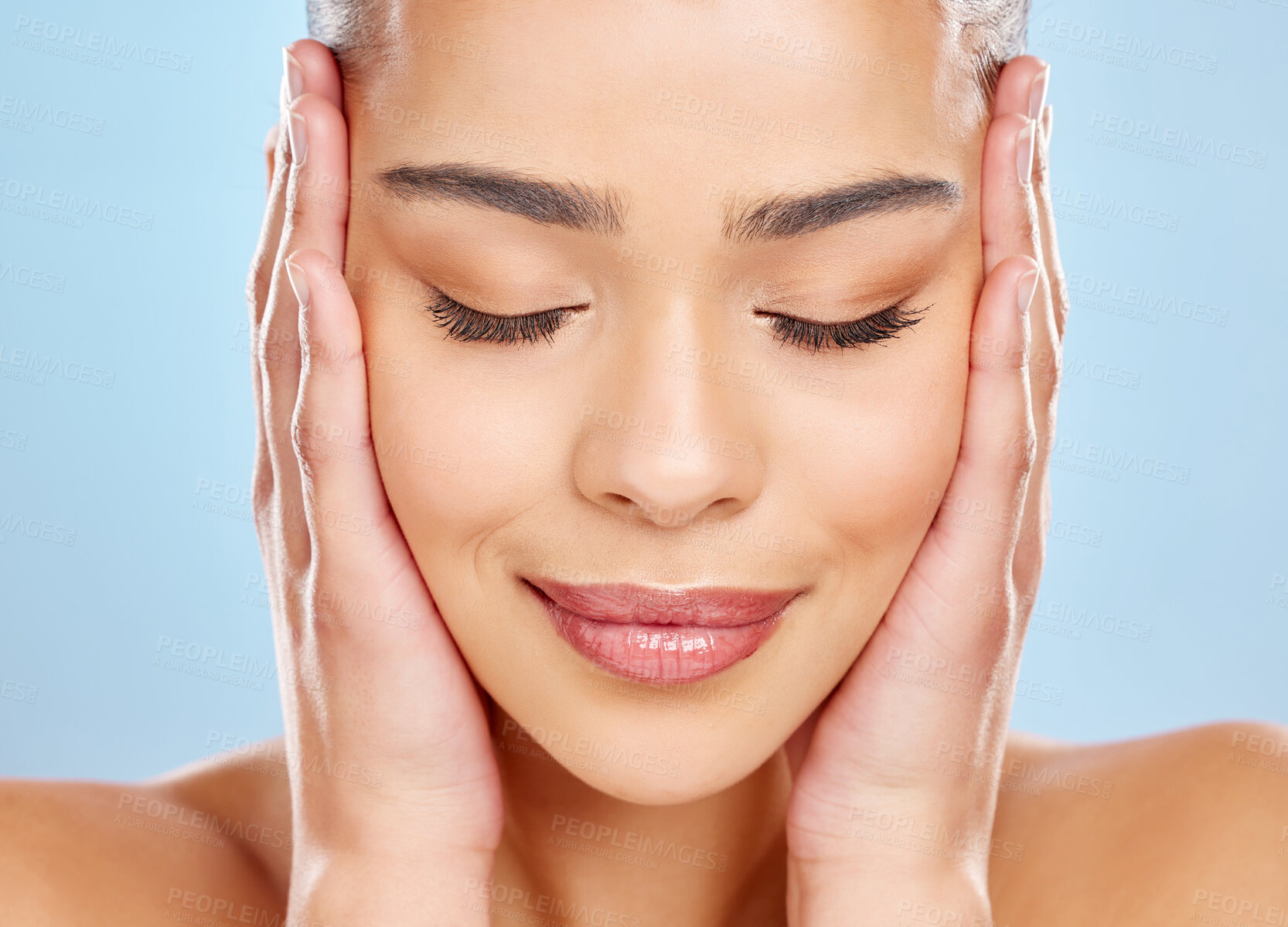 Buy stock photo Skincare, model girl and zen with hands in studio for beauty, glow and dermatology or cosmetics. Woman, wellness and results for self care and collagen by blue background and relax from facial