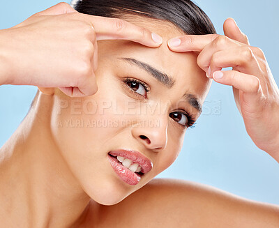 Buy stock photo Woman, portrait and stress for squeeze pimple with acne problem, skincare check and skin health crisis in studio. Female person, inspection and press face or pop zit with scar by blue background