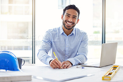 Buy stock photo Shot of a young male architect working in an office