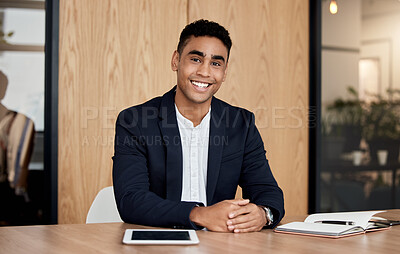 Buy stock photo Shot of a confident businessman sitting in his office