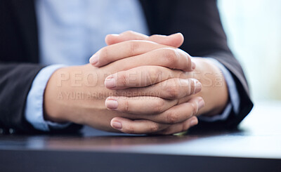 Buy stock photo Cropped shot of an unrecognisable businesswoman sitting alone in his office with his hands clasped