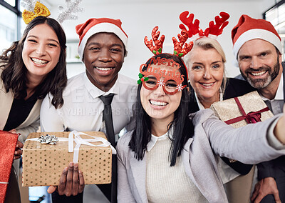 Buy stock photo Friends, selfie and business people at christmas party in the office with silly accessories. Diversity, smile and happy corporate colleagues taking picture together with gifts at festive celebration.