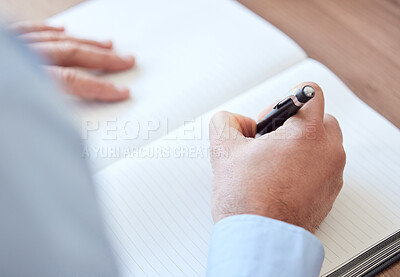 Buy stock photo Shot of an unrecognizable businessperson writing in a notebook at work