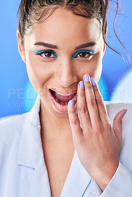 Buy stock photo Studio shot of an attractive young woman posing with balloons against a blue background