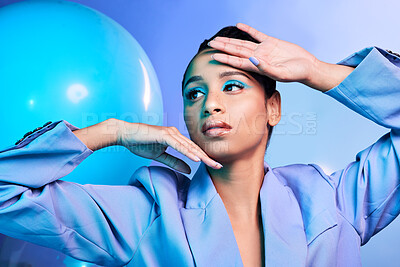 Buy stock photo Studio shot of an attractive young woman posing with balloons against a blue background