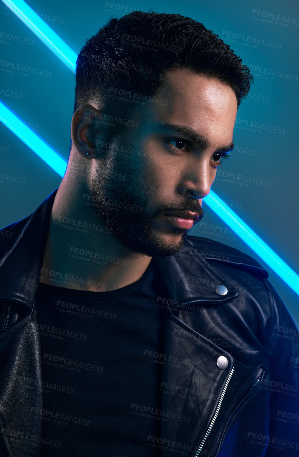 Buy stock photo Conceptual shot of a stylish young man posing in studio against a blue background