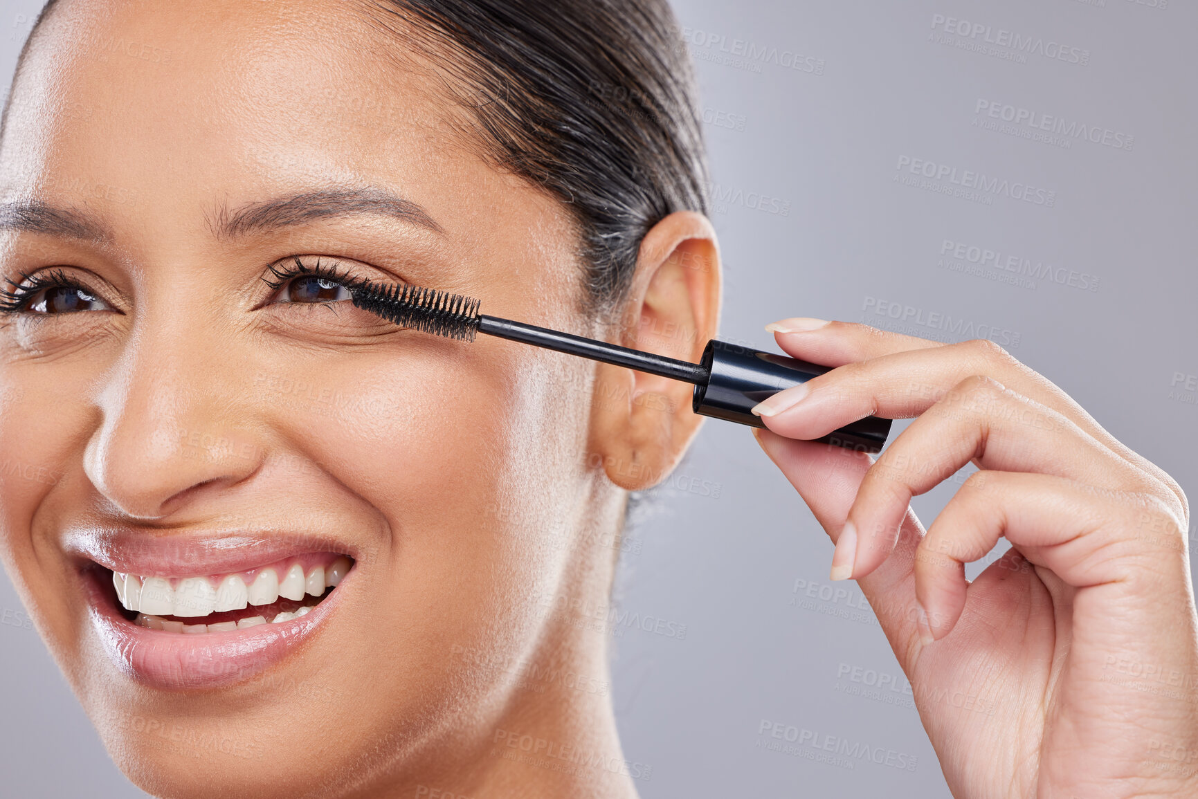 Buy stock photo Makeup, mascara and happy woman with brush in studio for beauty, cosmetics and application on grey background. Eyelash, smile and face of Indian lady model with tool for volume, glamour or aesthetic