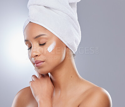 Buy stock photo Studio, woman and towel for cream or cosmetics, moisturizer and hand on white background. Skincare, dermatology and beauty for female person, calm or relax for lotion with glow and product on face