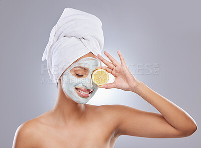 Buy stock photo Mask, skincare and lemon with woman in studio for beauty, natural cosmetics and vitamin c. Self care, glow and spa with face of female model and citrus fruit on grey background for detox product