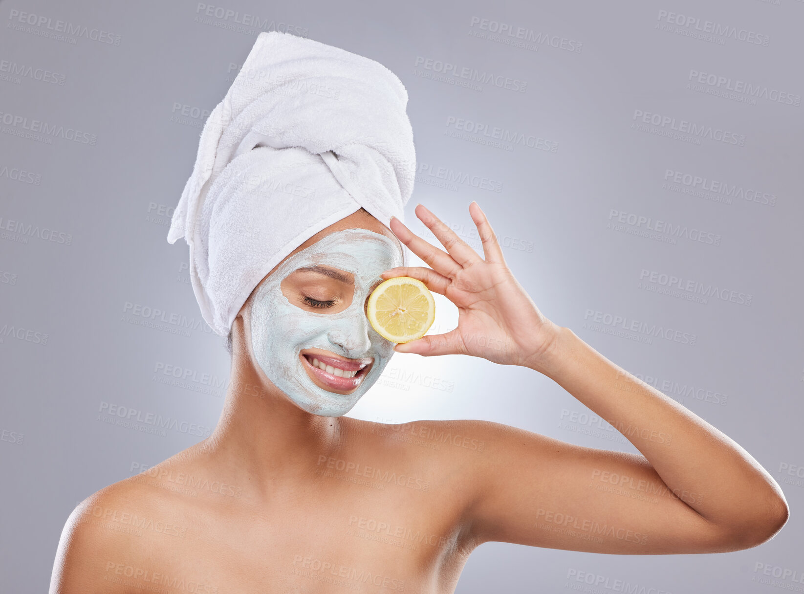 Buy stock photo Mask, skincare and lemon with woman in studio for beauty, natural cosmetics and vitamin c. Self care, glow and spa with face of female model and citrus fruit on grey background for detox product