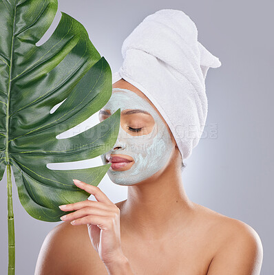 Buy stock photo Leaf, skincare and woman with face mask in studio for dermatology and haircare on grey background. Plant, facial and female model with organic, beauty and eco friendly, wellness and body care