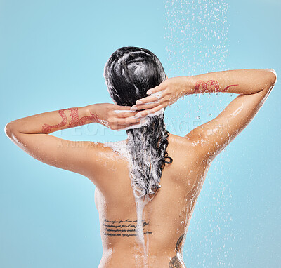 Buy stock photo Shot of a beautiful young woman enjoying a shower against a blue background