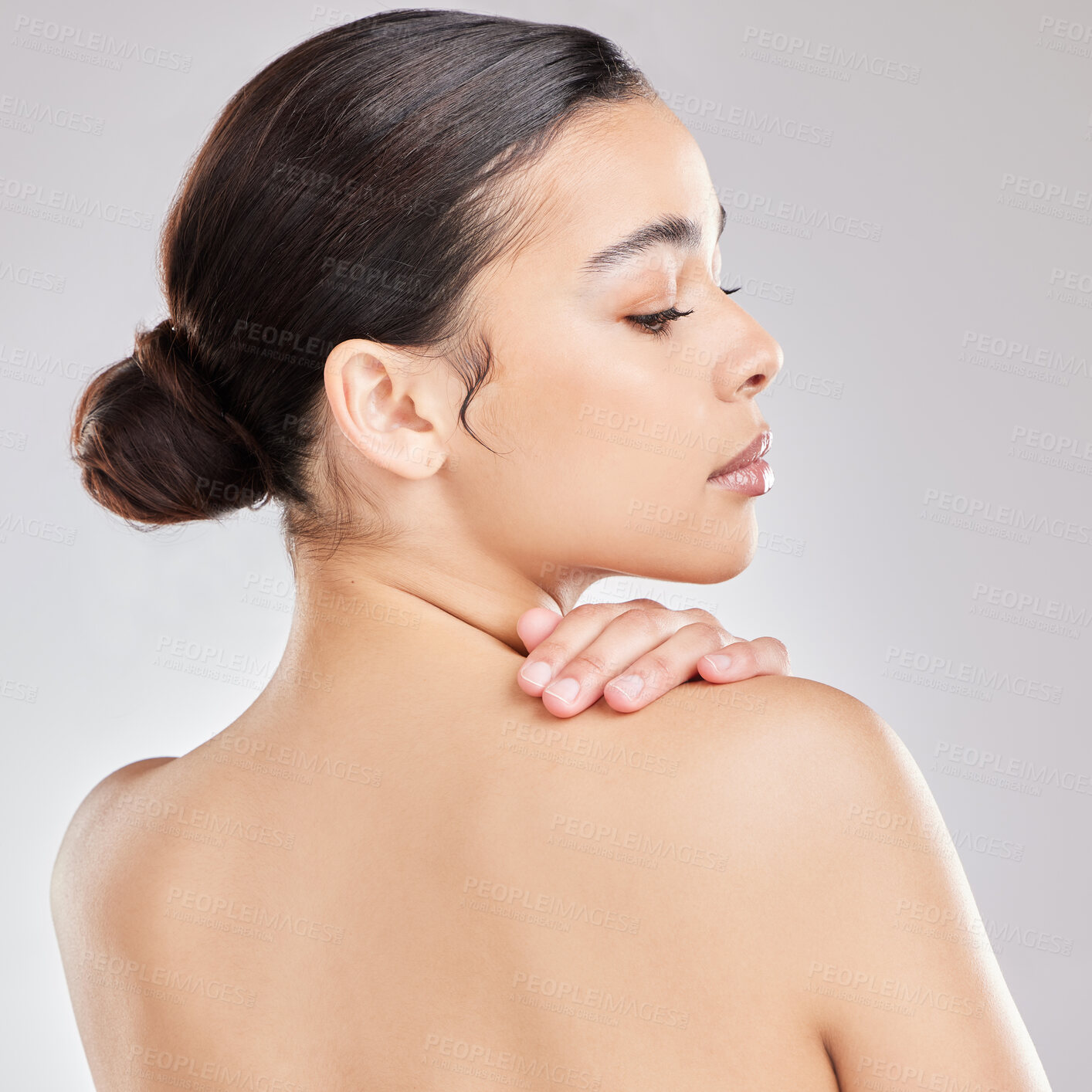 Buy stock photo Shot of a young woman posing against a grey background