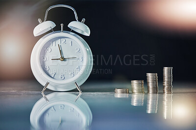 Buy stock photo Shot of an alarm clock and coins on a desk in an empty office