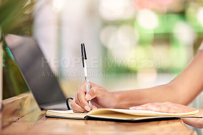 Buy stock photo Shot of a nursery owner using a laptop and making notes