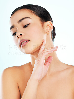 Buy stock photo Studio shot of an attractive young woman posing against a light background