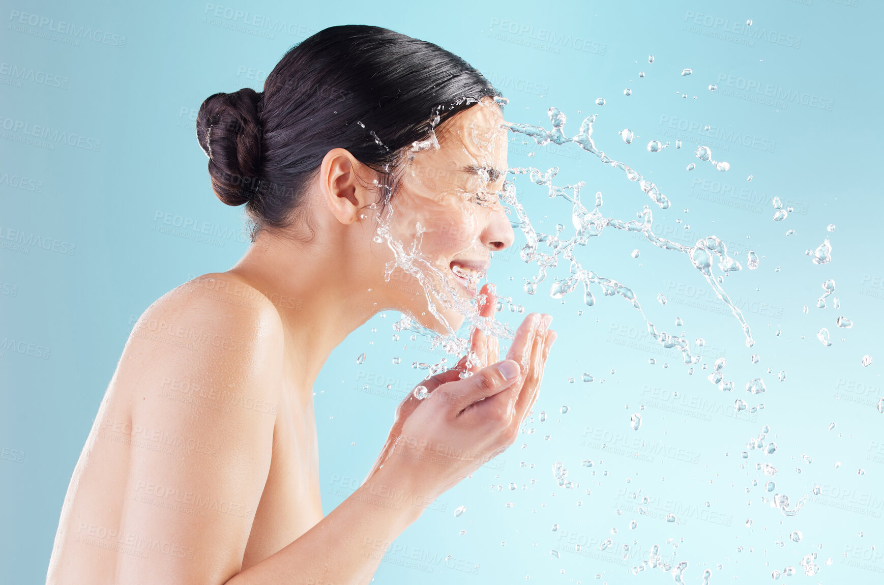 Buy stock photo Studio, woman and profile with water splash in face for natural hygiene, skincare and morning routine. Happy, hand and person with liquid for cleaning, hydration and dermatology on blue background