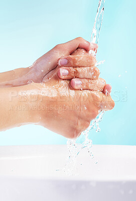 Buy stock photo Person, water and washing of hands in studio for bacteria, hygiene and germ protection in basin. Cleaning, skin hydration and body care with liquid for disinfectant or virus safety on blue background