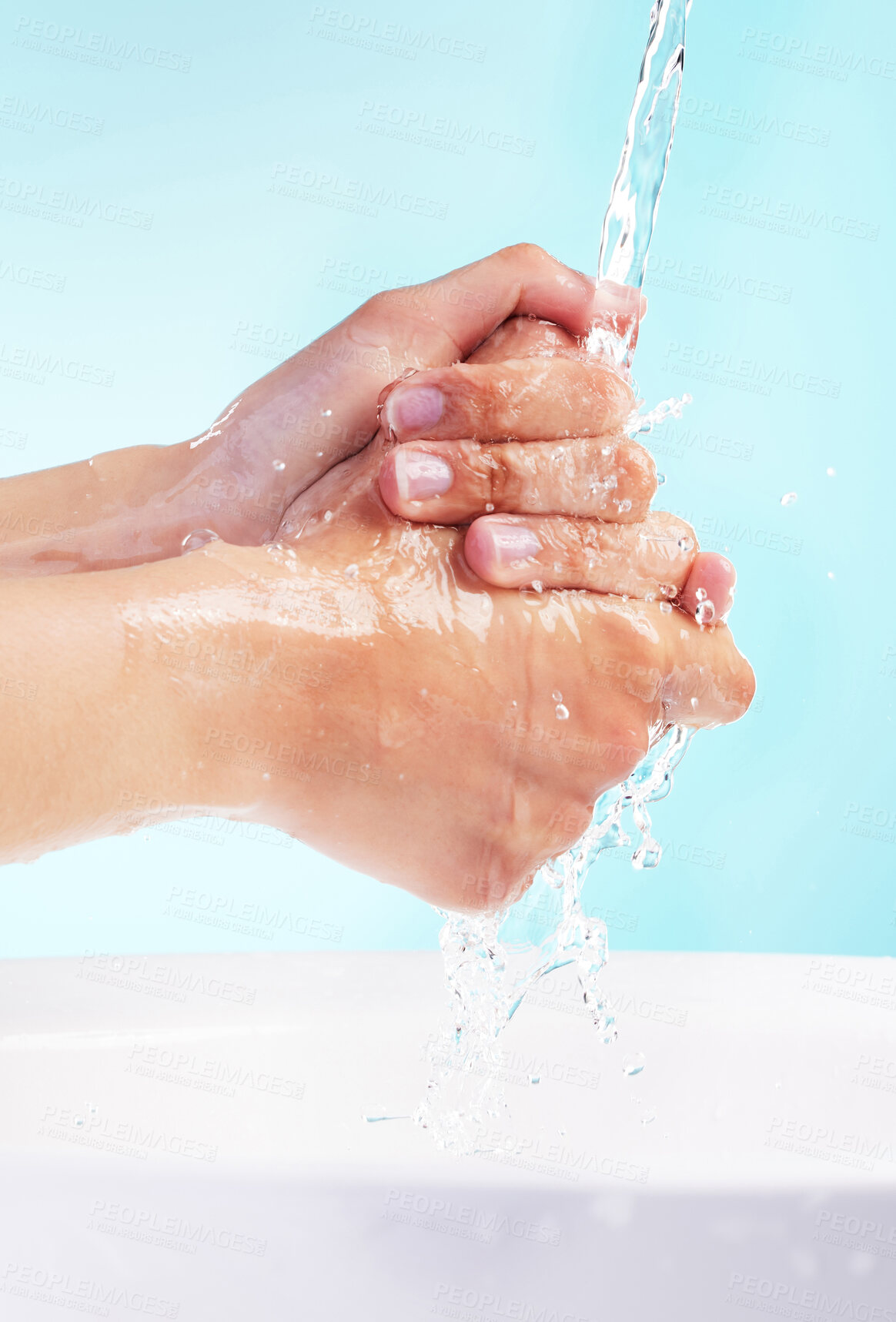 Buy stock photo Person, water and washing of hands in studio for bacteria, hygiene and germ protection in basin. Cleaning, skin hydration and body care with liquid for disinfectant or virus safety on blue background