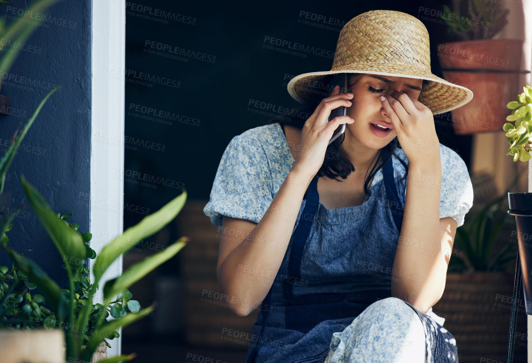 Buy stock photo Mental health, woman florist with headache and with smartphone on a phone call with a client at her workplace. Anxiety or stress, sad and female person talking on a cellphone for customer service.