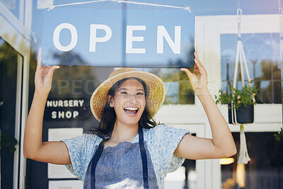 Buy stock photo Portrait, nursery and open with a woman hanging a sign in the window of her shop for gardening. Small business, garden center and an excited young female entrepreneur opening her new flower store