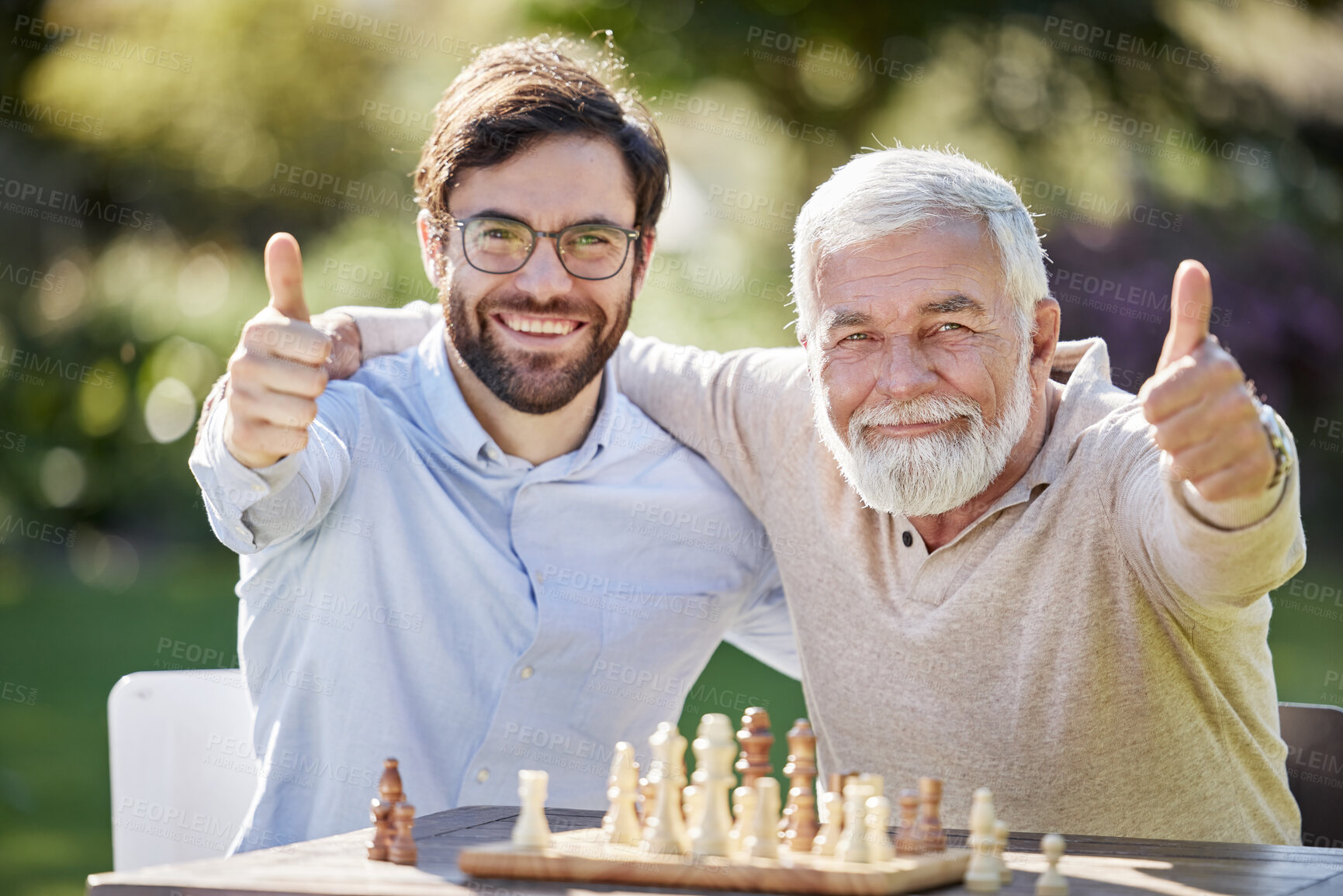 Buy stock photo Thumbs up, men and chess in garden for retirement, friends and strategy contest or winning with pride. People, together and family in countryside for senior man, son and board games in park or nature