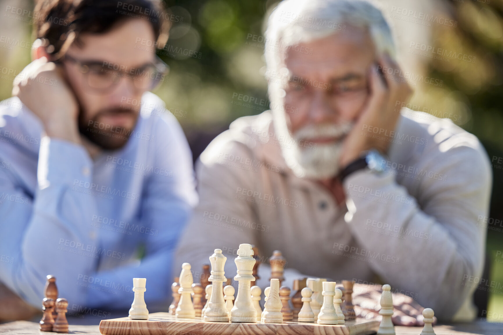 Buy stock photo Chessboard, men and playing game in garden or park with friends, strategy and ideas in nature. People, together and thinking or planning in countryside for senior man and challenge in retirement home