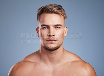 Buy stock photo Studio shot of a handsome young man posing against a grey background