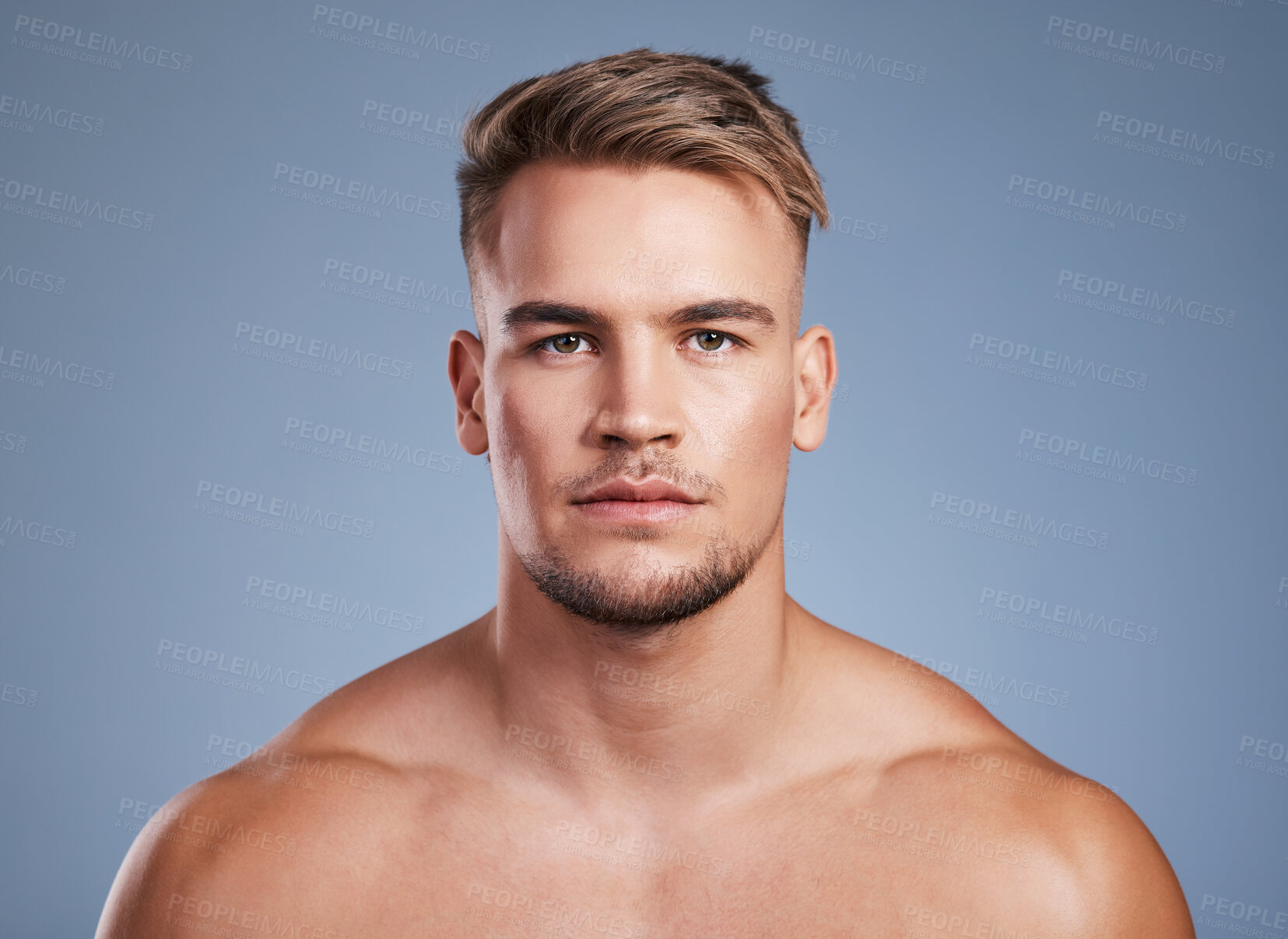 Buy stock photo Studio shot of a handsome young man posing against a grey background