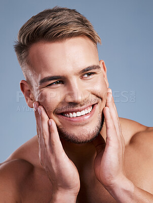 Buy stock photo Closeup shot of a handsome young man smiling while posing against a studio background