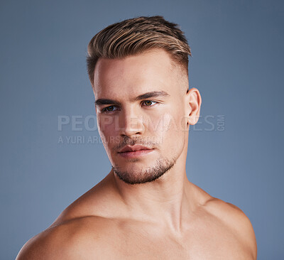 Buy stock photo Studio shot of a handsome young man posing against a grey background