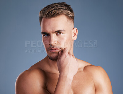 Buy stock photo Studio shot of a handsome young man posing against a grey background