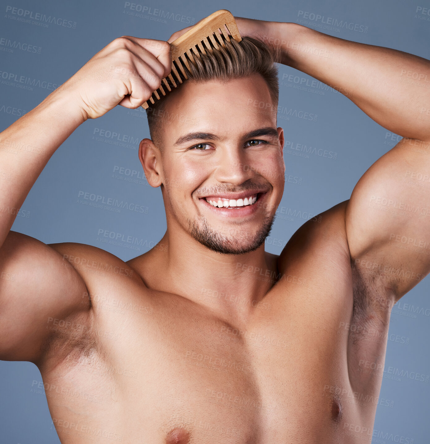 Buy stock photo Shot of a handsome young man combing his hair