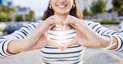 Buy stock photo Shot of an unrecognisable businesswoman making a heart shaped gesture with her hands outside