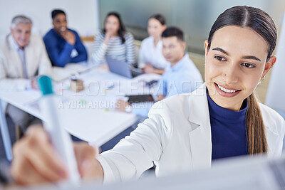 Buy stock photo Shot of a young businesswoman writing on a board during a meeting at work