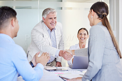 Buy stock photo Shot of two businesspeople shaking hands in a meeting at work