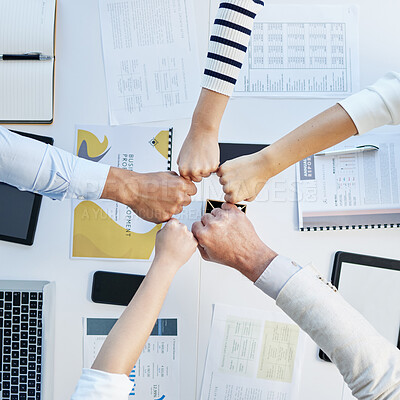 Buy stock photo Top view, hands circle and fist bump in office for motivation, team building and collaboration with proposal. Business people, solidarity and together for teamwork, group vision and paperwork on desk