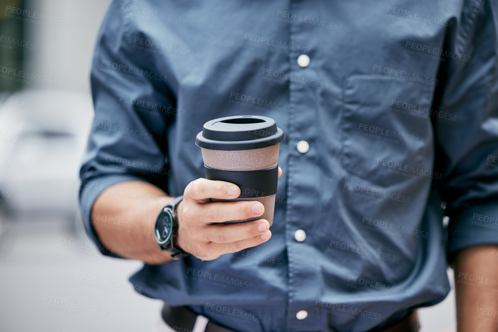 Buy stock photo Cropped shot of an unrecognizable businessman holding a takeaway coffee while standing in his office