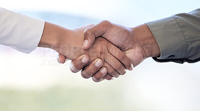 Buy stock photo Closeup shot of two unrecognisable businesspeople shaking hands in an office