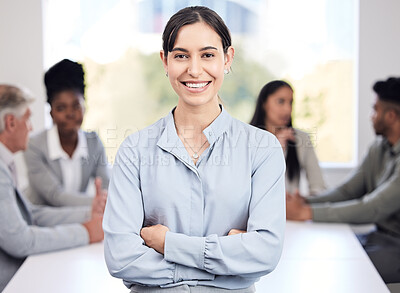 Buy stock photo Portrait, smile and a business woman arms crossed in a boardroom with her team planning in the background. Leadership, workshop and confidence with a happy young female employee standing in an office