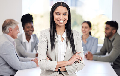 Buy stock photo Portrait, happy and a business woman arms crossed in a boardroom with her team planning in the background. Leadership, workshop and smile with a confident young female employee standing in the office