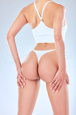 Buy stock photo Studio shot of an unrecognizable woman posing in her underwear against a grey background